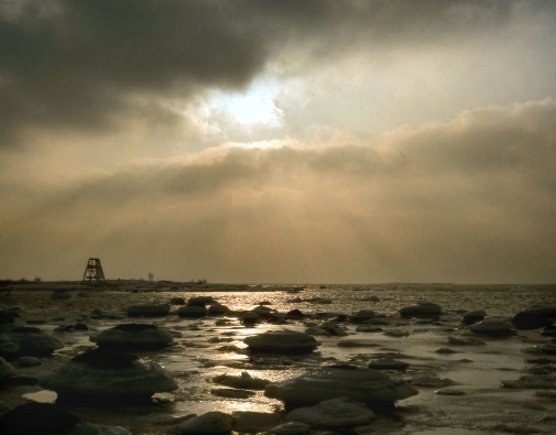 Sun shining through cloudy sky over the Baltic Sea